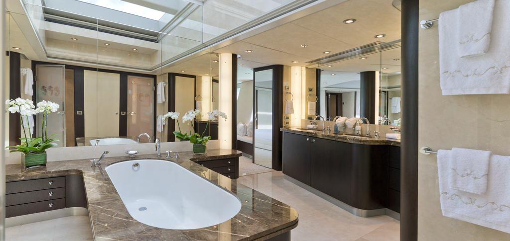 MASTER SUITE The sleek marble and metal finishes of the marble bathroom are complemented by lush, high
