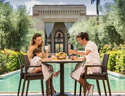 Enjoy La Palmeraie's delicious international cuisine on the charming terrace with flowering shrubs and ponds.