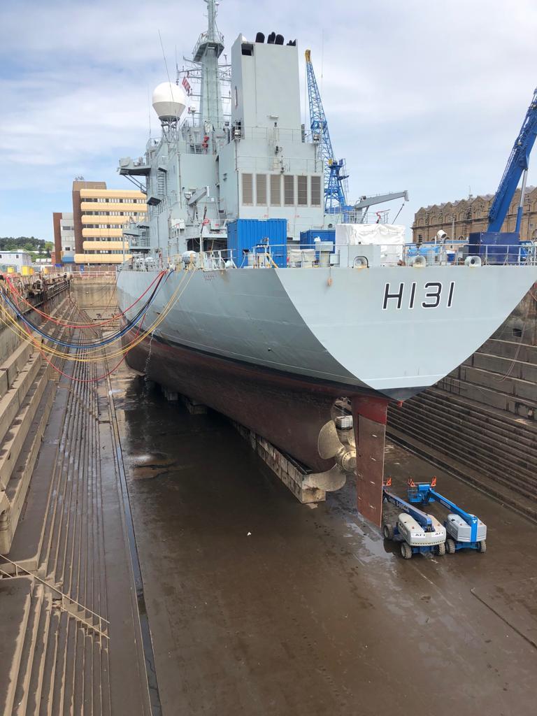 HMS SCOTT in dry dock. Right: The rudder being reattached.