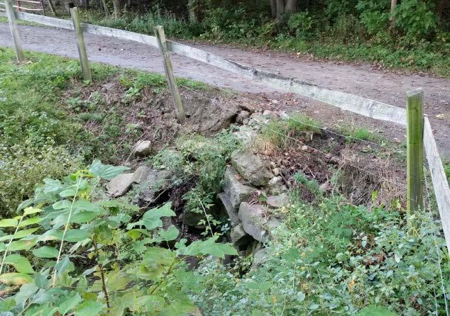 The pipe ends were being eroded by the road ditch and the pipe was clogged to the point of overtopping the lane and road.
