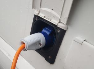 Connecting your motorhome to the site electricity In the rear storage compartment of the motorhome is a blue bag containing a lead to connect the motorhome to the site electricity.