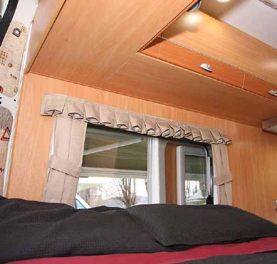 Lifting the bed reveals an acrossthe-van compartment at the front for items like camp chairs, broom and awning handle. Further back is a shallow storage area that is nicely compartmented.