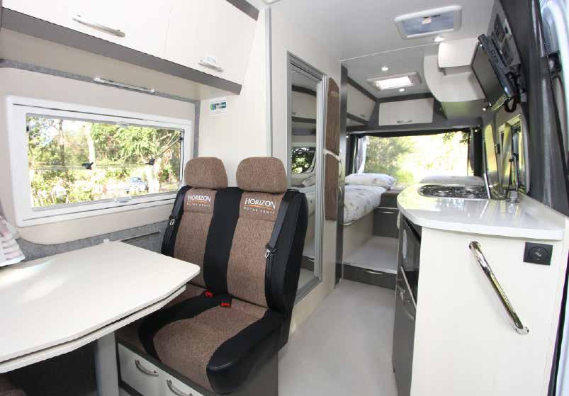 Up front the cab seats swivel around and there s a forward-facing passenger seat for two on the driver s side, with a removable dining table between them and