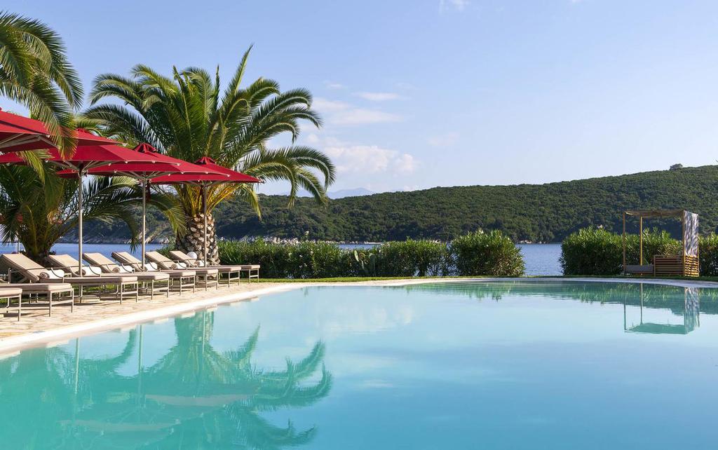 BELLA MARE CORFU Bella Mare Hotel in Corfu is set right on the awarded Avlaki beach and is a seafront paradise embraced by a magnificent green scenery.