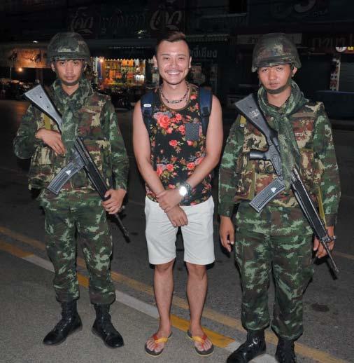 In Bangkok, the atmosphere is lively as ever as tourists pose for photographs with soldiers on the streets and life returns to normal with