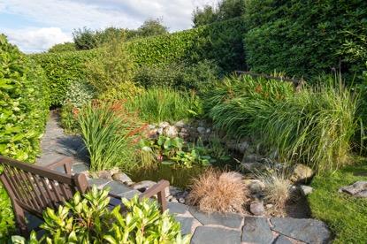 Outside The beautifully landscaped private gardens encompass the property, with attractive pond area, vegetable garden with
