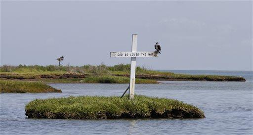 Islanders in Chesapeake Bay face exile from rising seas 10 December 2015, bysteve Szkotak In this Sunday May 27, 2012 photo, an Osprey sits atop a cross erected in the waterway leading to the harbor