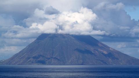 largest active volcano, Stromboli belches imposing clouds of steam skywards.