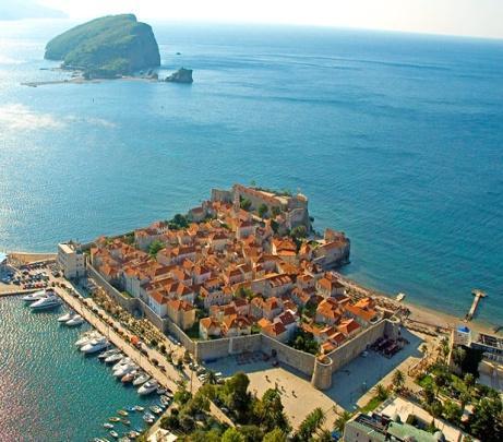 Montenegro. The former fishing village of Sveti Stefan is perched on a rocky island linked to the shore by a narrow causeway.