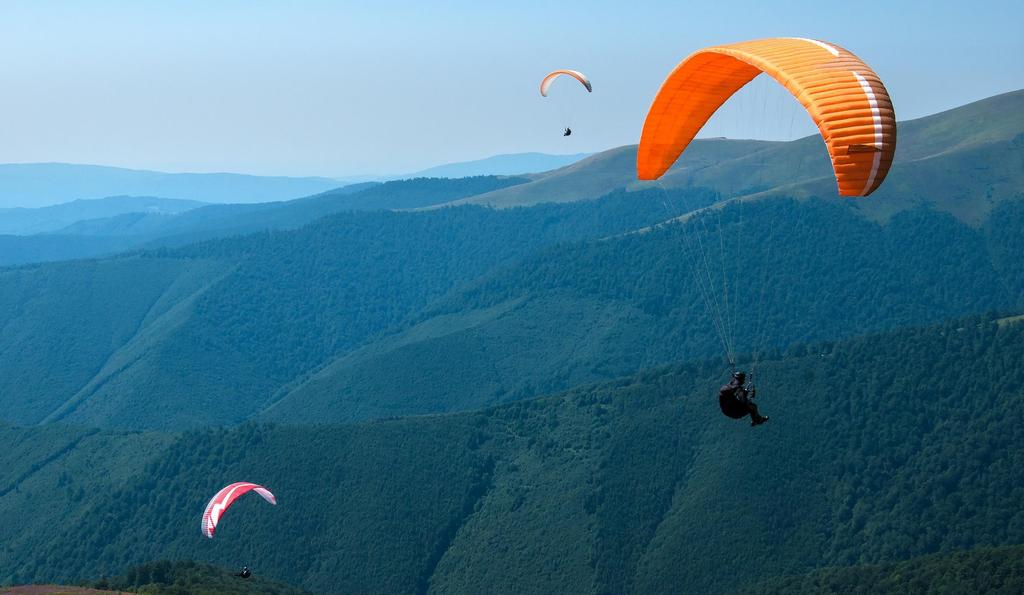 PARAGLIDING Allow yourself to be carried by the wind, swirling in the air over Caucasus Mountains and gliding