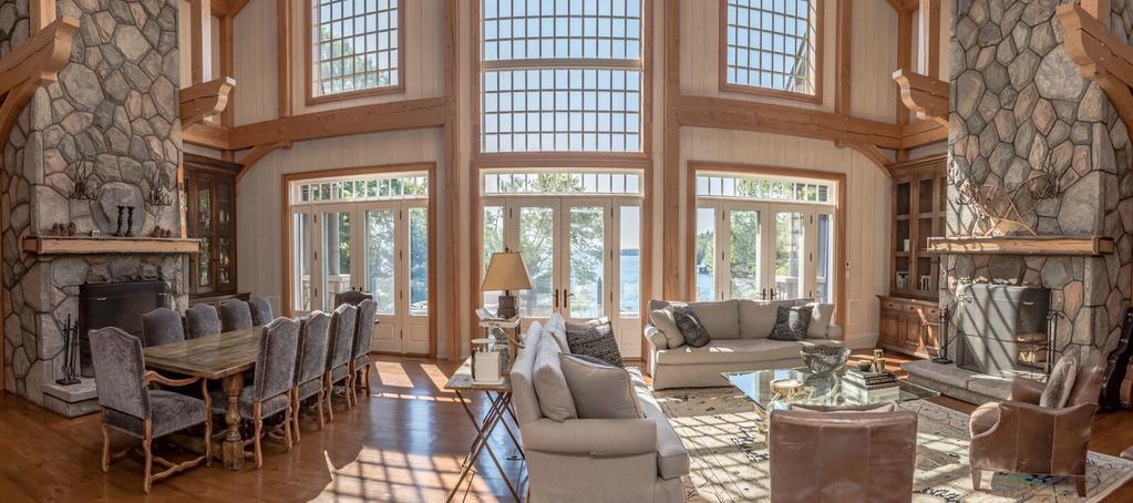 Main Floor The entry hall has radiant floor heating and opens on to the Great Room with soaring ceilings and stunning lake views Matching stone fireplaces are flanked either side with custom