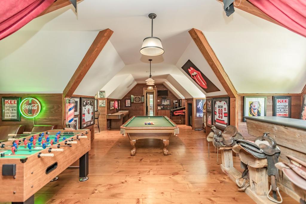Currently set up with: o Pool table o Shuffleboard o Foosball bar o Juke box o Elvis pinball machine Connecting the guest and family wings is a walkway overlooking the Great Room with views to