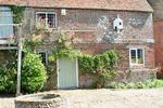 It is part of a working farm which includes cattle, farmyard, stables, 15th century barn, cart sheds and a thatched