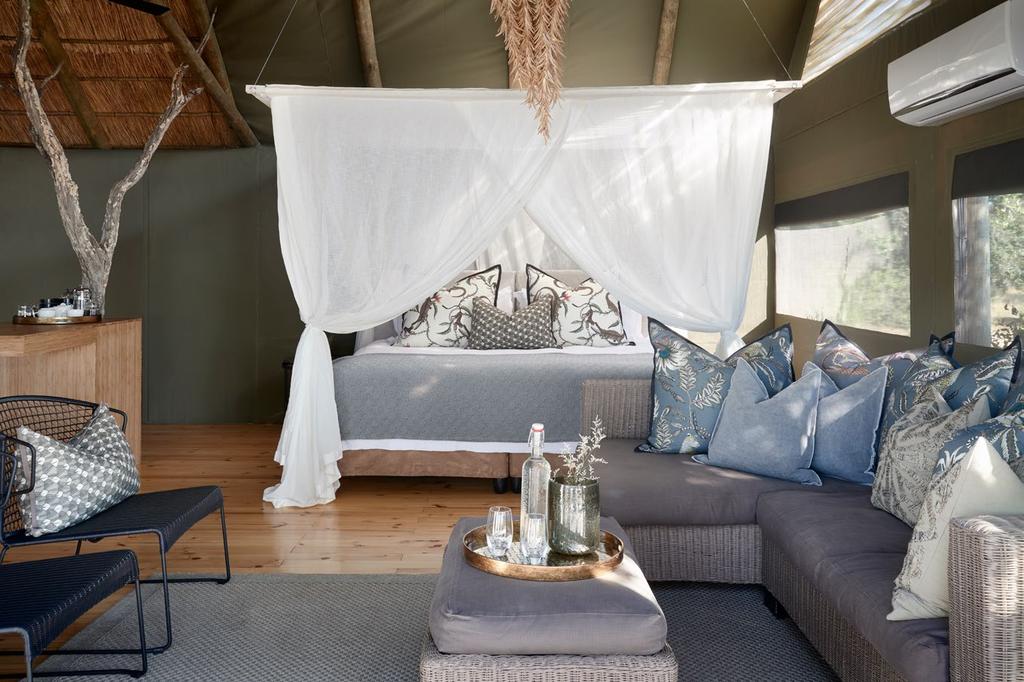 overlooking the legendary Zambezi River Spacious bedroom and sitting areas Open-plan,