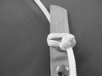 between the existing knot and the grommet.