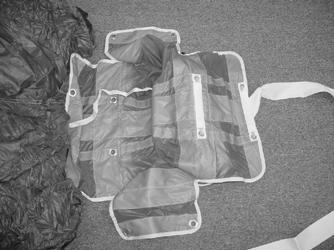 folded parachute. Leave the packing paddles in place to prepare for the next half S-fold.