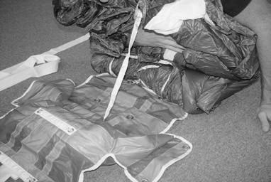 SECTION: PACKING TMAN 002-FEB 2005 - REV 0 Kneeling on the lower tail, pull the top of the folded reserve up onto your