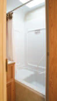 Roomy bath facilities include a one-piece tub