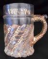 ) Estimate: 5-0 7 Lot # 77 - Mug made of glass with gold painted beading and gold writing around edge "World's Fair St. Louis - 1904". Gold is also on the beading on the glass handle.
