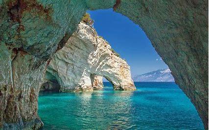Famous landmarks include the Navagio beach and beautiful blue caves cut into cliffs around Cape Kinari, only accessible by small boat.