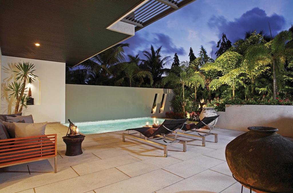 Outdoor Living A Large, Tropical Space Strategically placed dividing walls and lush, tropical flora