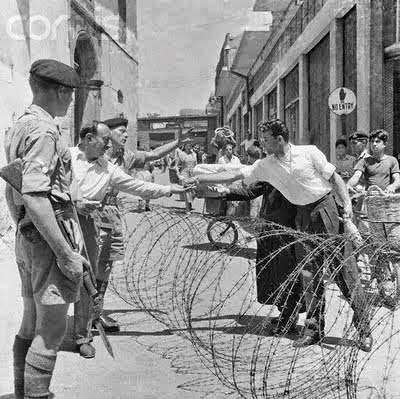 1878 1923 1931 1950 s 1959 1956 Photo of Hermes street and the transactions over the berbed wire after the seperation between the north and south of Nicosia, 1956. British soldiers stand guard.