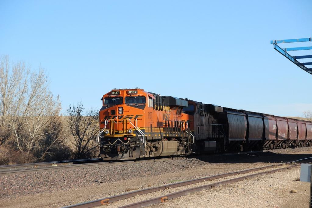 BNSF 8137, a GM SD60M, with an unknown BNSF locomotive, is parked on the mainline