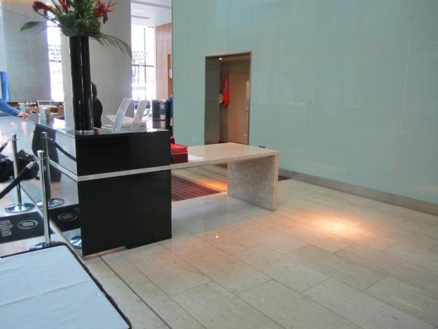 Check in is at the main reception desk. The low easy check in desk (1.1m high) is located at the far side of reception towards the spiral staircase.