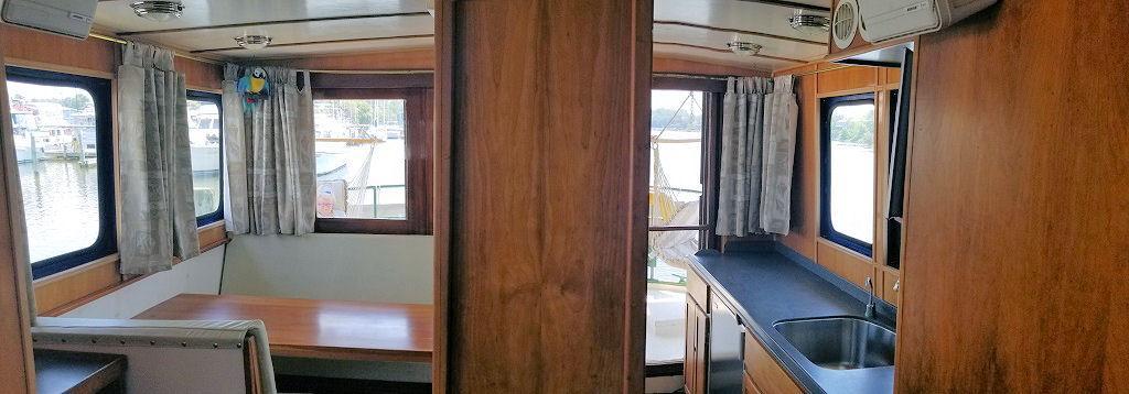 Next, up top in the deck house with it s large galley, dining area, bridge, helm and navigation station.