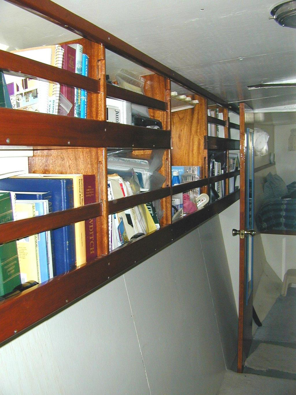 This is an old picture looking aft through the starboard side midships passageway and library toward the master cabin.