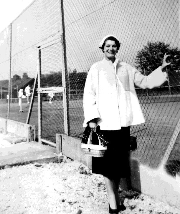 I couldn t find a photo of me playing tennis but one photo by the tennis courts looking smart with my favourite basket handbag.