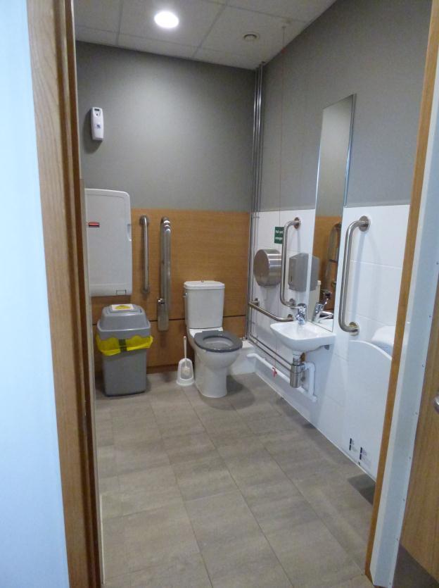 These toilets have a unisex accessible toilet with changing facilities and are described below: There are vertical rails either side of both basin and toilet.