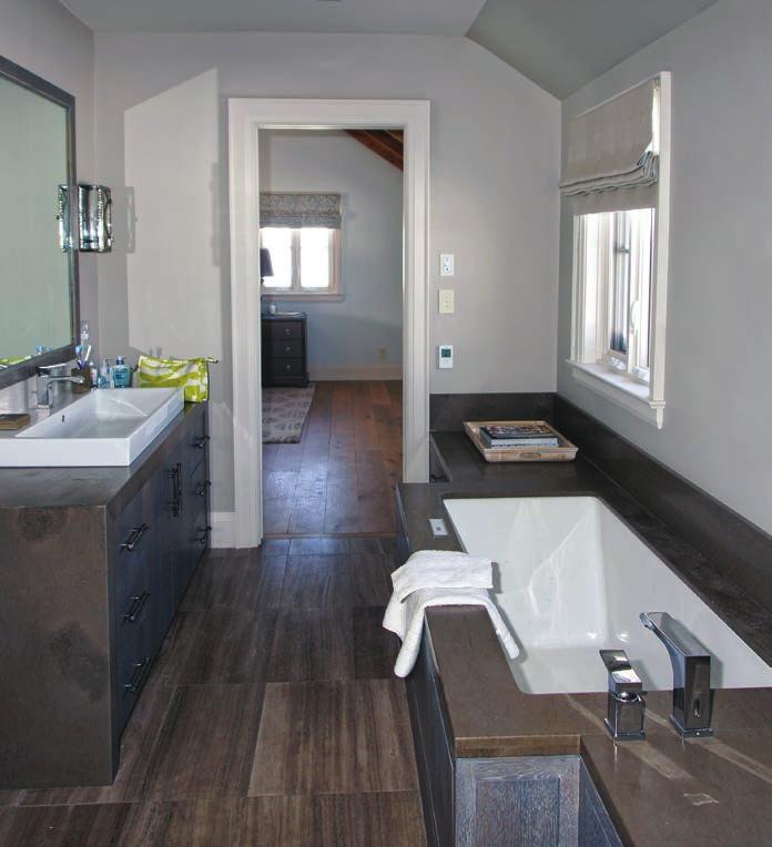 The minimalist yet luxurious master bath is ensuite to the