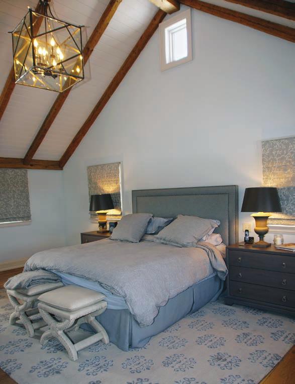 The high-ceilinged, spacious master bedroom has a subdued colour palette.