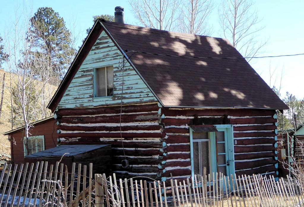 DESCRIPTION: 114 Redtail Road The cabin at 114 Redtail Road is a one-and-a-half story pioneer log building with a frame shed roof addition on the rear (east).