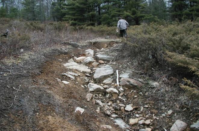 A well-constructed trail foundation of coarse soil material (i.e., sand, gravel, or rock) and Reduced water concentration and velocity.