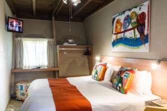 affordable overnight accommodation in colourful rooms within A-frame buildings.