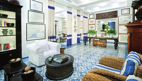 Vintage maps, plantation-style furniture and richly patterned floor tiles create a colonial-tropical