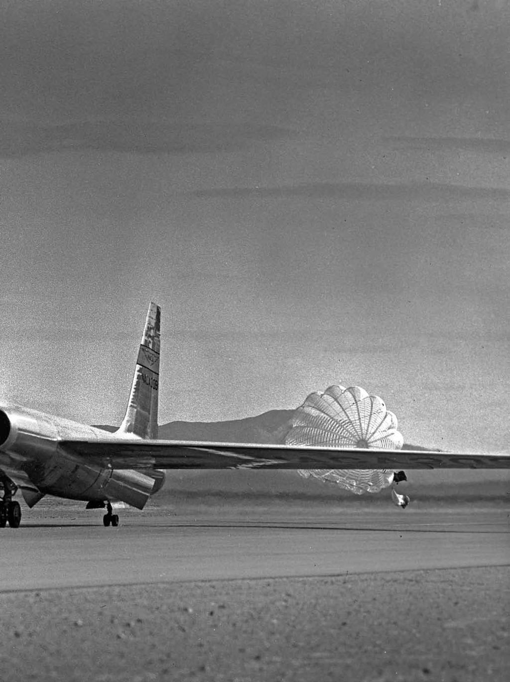 atone An early U-2 reconnaissance airplane, speed brakes and landing chute deployed, lands at Groom Lake, Nev., in the mid-1950s.