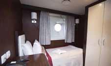 two single beds, private bathroom, and DECK 4 a window. Located on the Columbus and Marco DECK 4 Polo Deck.