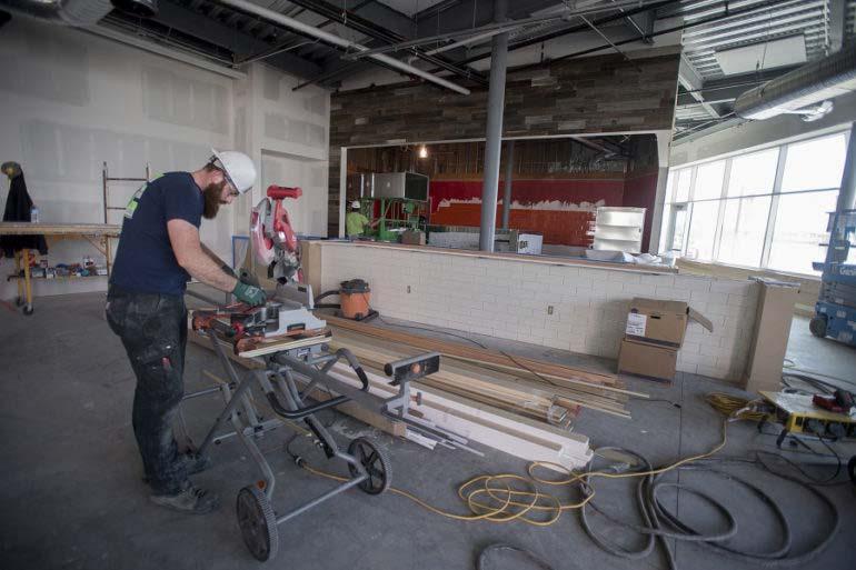 Stuart Morton of R. Miller Inc., lends a hand to the construction of WildFin American Grill on Monday morning.