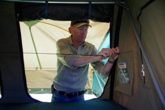 Then climb inside the tent, and undo the 4 bungee cords.
