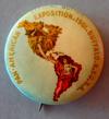 Estimate: - 2 Lot # 84 - Round Celluloid Pin Back showing the full color Raphael Beck design of two women in the shape of North and South America holding hands through Central America.