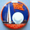 The enamel disk has a Trylon & Perisphere with "1939" inside the blue enamel and "New York World's Fair" in red enamel. Size: Overall it is 2 1/2" wide by 3/4" high. The disk is 9/16" diameter.