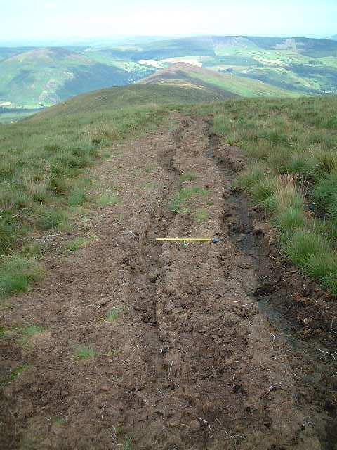 32 30m on pic12 looking ahead shows 20cm deep tyre tracks in the soft peat; tape 0.
