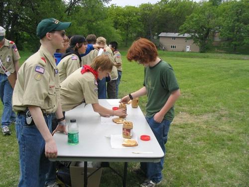distance of about 25 to 30 feet) by lifting the can on the board without spilling any water. If any water spills, the Scouts must start over.