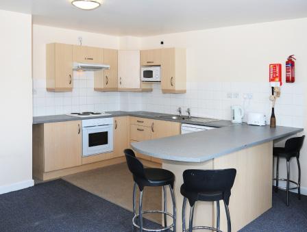 Each flat has a fully furnished kitchen and living area.