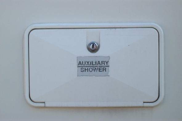 Auxiliary Shower On the exterior driver side of the RV, is an auxiliary shower which can be used to rinse off before entering the RV. If the RV is hooked up to a park water source, it is functional.