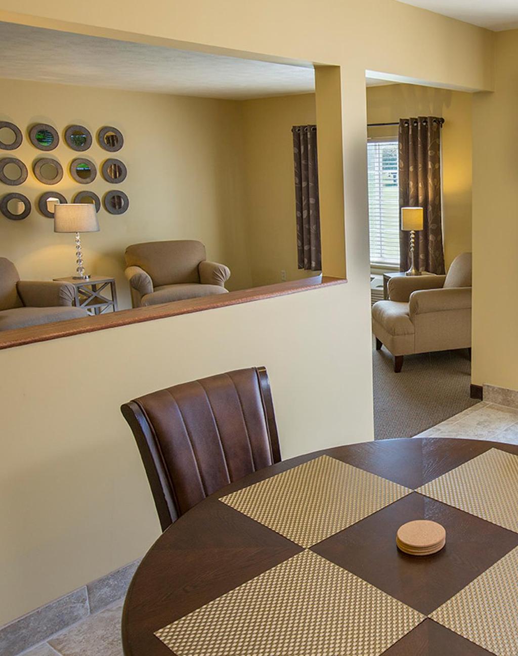 The suite also has a kitchenette with dining table and access to a private outdoor deck.