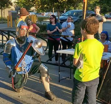 Lots of people stopped to take photos of the mysterious knight in armor graciously taking a beating from the young boy. Check out that great footwork.